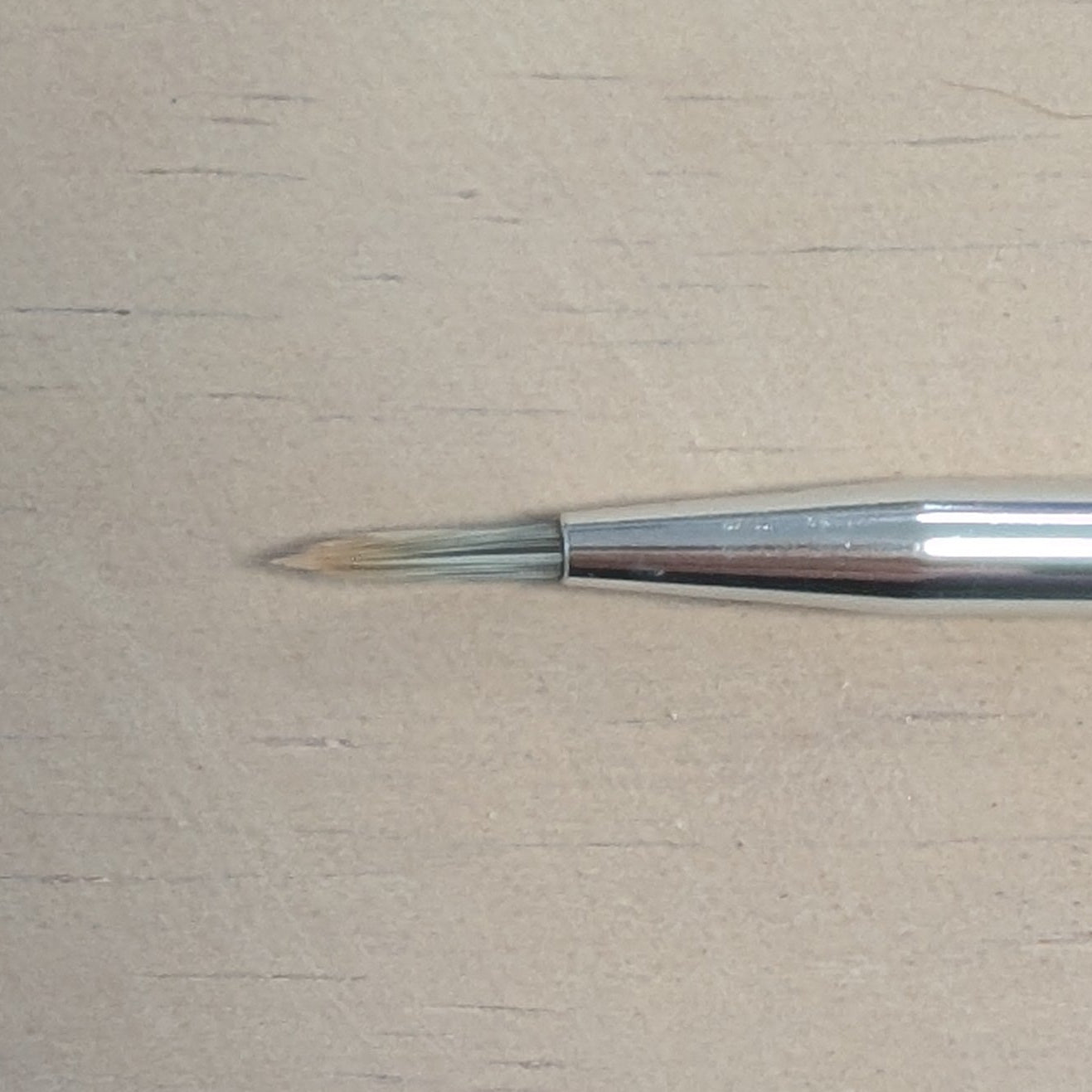 Paintbrush on a beige surface
