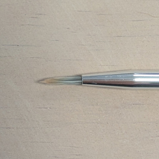 Paintbrush on a beige surface